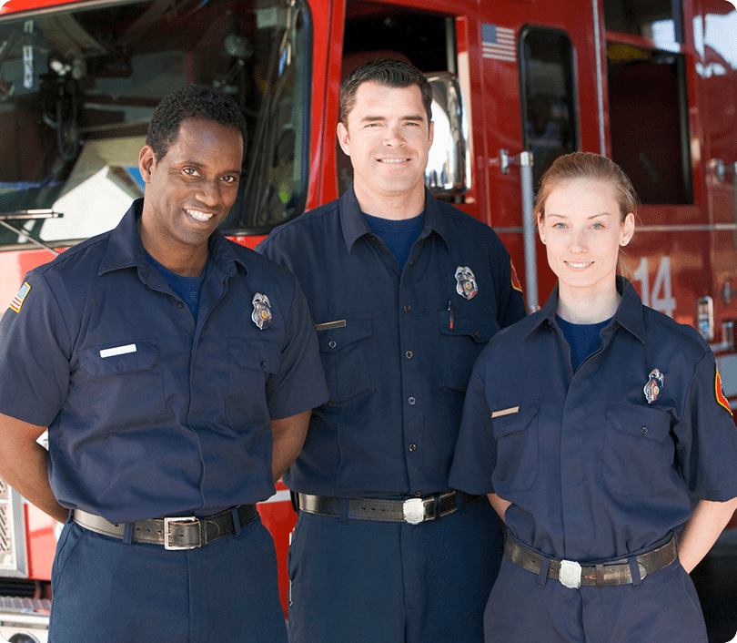 Firefighters standing in front of fire truck.